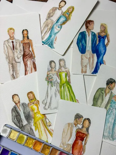 Faceless watercolour fashion sketches of wedding guest couples on cards beside a paint palette, by Darcy Hart