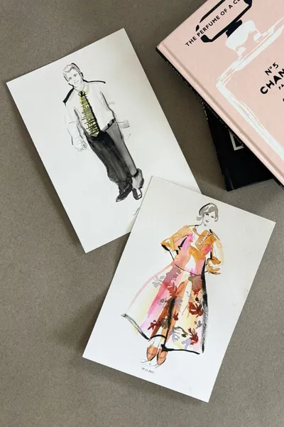 Live watercolour fashion sketches of two wedding guests, a man in a tie and a woman in a floral dress, by Erin Whitty