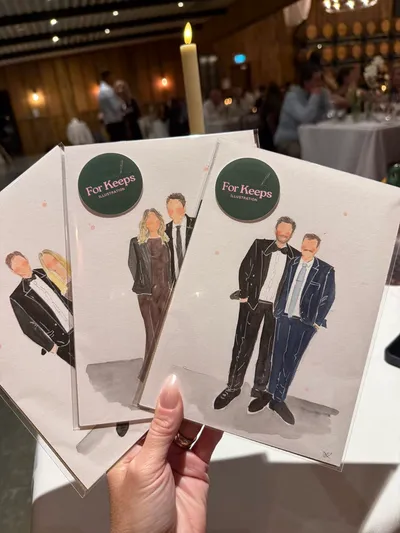 Live watercolour wedding guest portraits of three couples in formal wear, held up at a reception, by Kirsty Wyatt