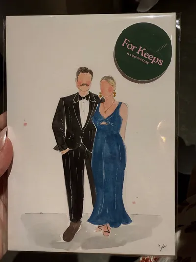 Live watercolour guest portrait of a couple in a tuxedo and blue gown, painted at a wedding by Kirsty Wyatt