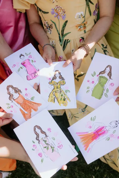 Live watercolour fashion illustrations of wedding guests in colourful dresses with rose motifs, by Grace Choi Artist