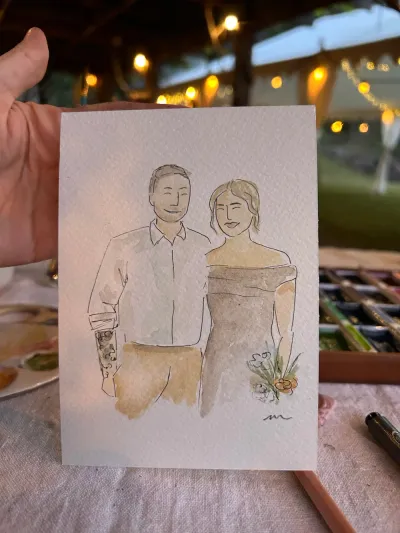Watercolour and ink live portrait of a couple held up at an evening event under festoon lights, by Just Sketched Art