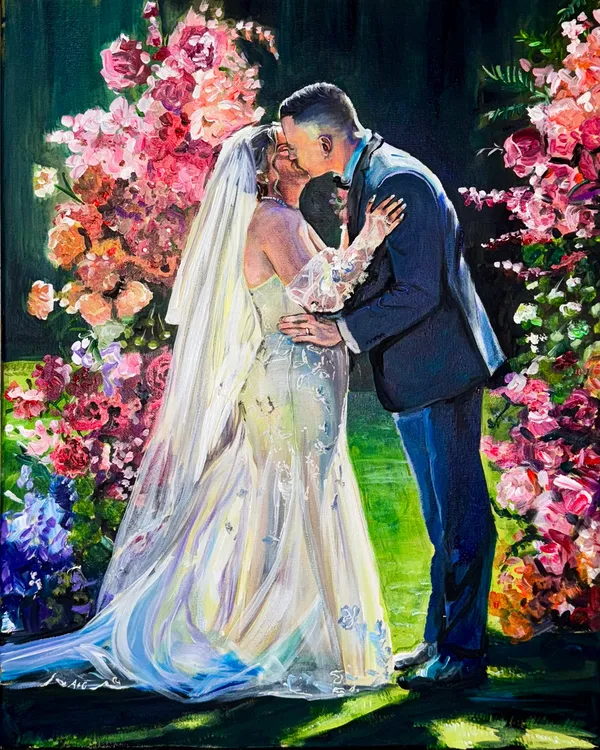 Acrylic live wedding painting of a bride and groom kissing between vivid pink floral arrangements, by Lauren I Ward