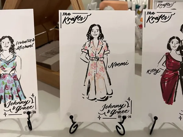 Ink and marker live guest sketches of women in floral and red dresses on personalised wedding cards, by Let Me Draw You